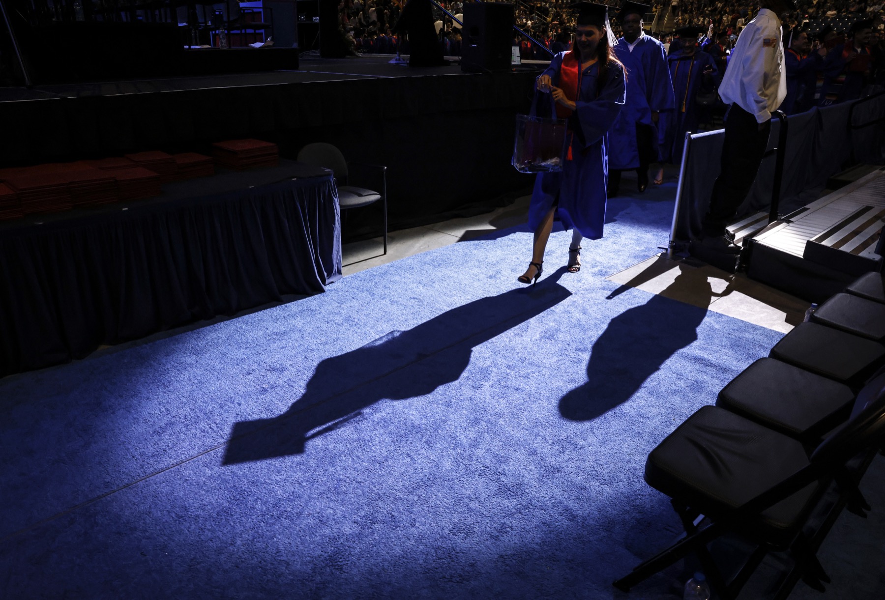 The last graduates of the first in-person commencement ceremonies since 2019 exit the Wintrust Area and enter the "real world."